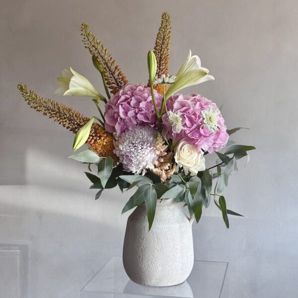 Seasonal Flowers in a White Ceramic Pitcher