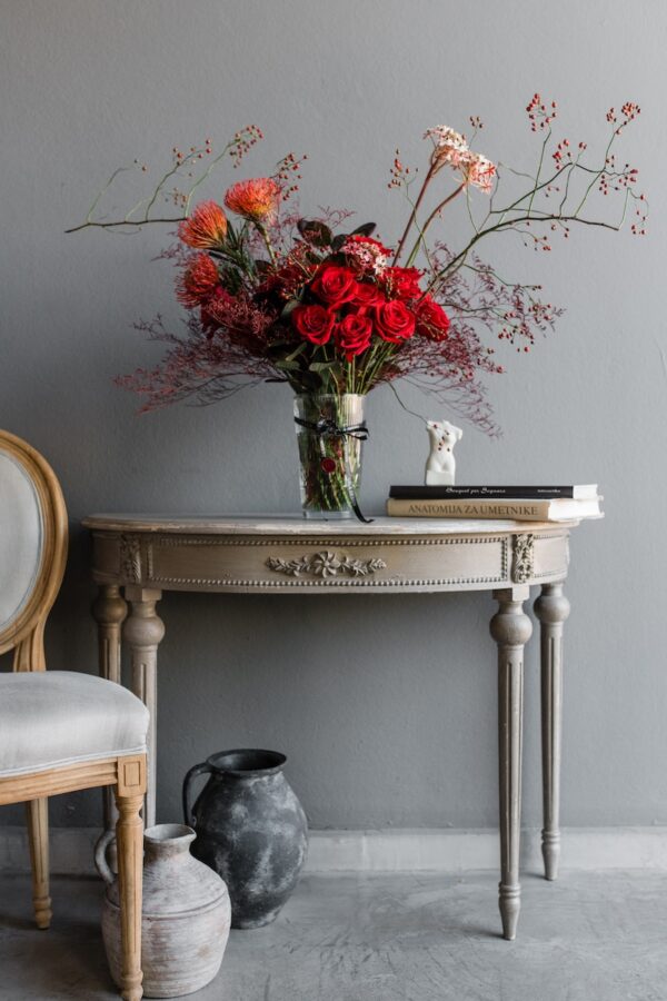 Red flowers in a vase by Lela Design 0