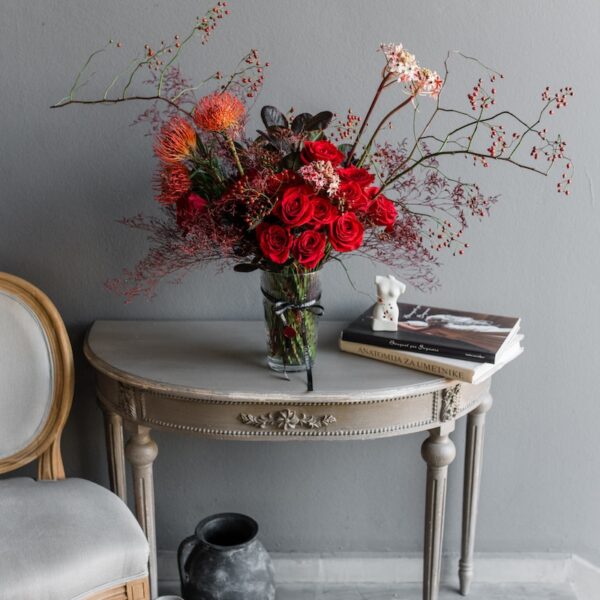Red flowers in a vase by Lela Design 1