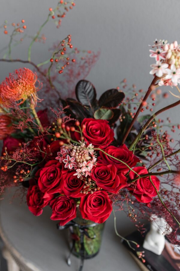 Red flowers in a vase by Lela Design 2
