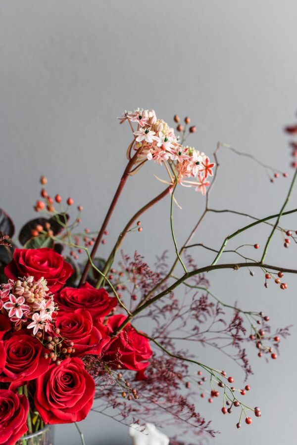Red flowers in a vase by Lela Design 3