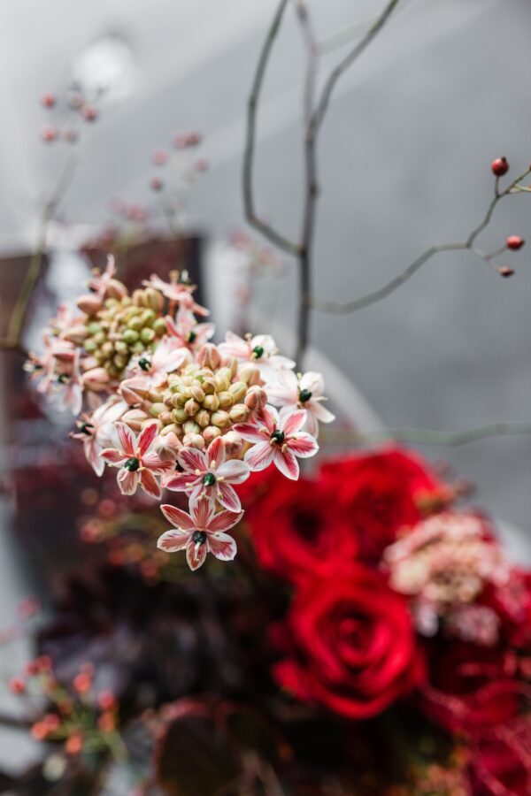 Red flowers in a vase by Lela Design 4