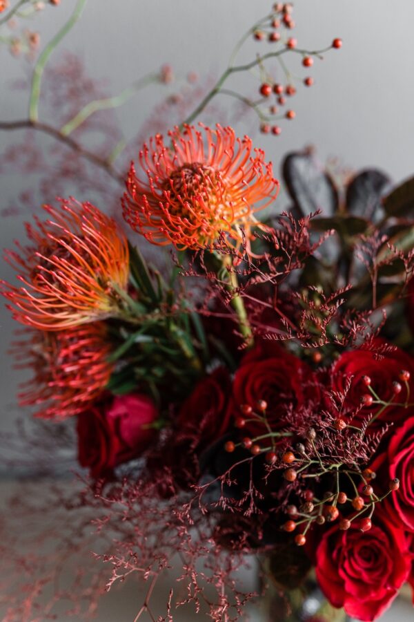 Red flowers in a vase by Lela Design 5